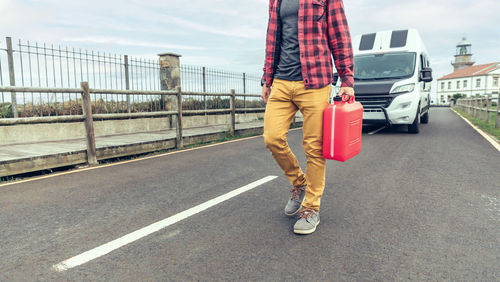 Low section of woman walking on road