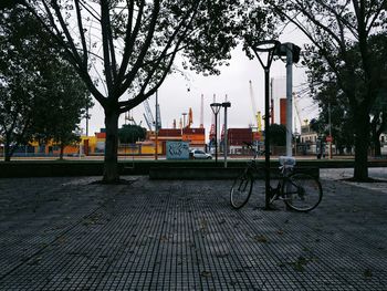 Bicycle in city against sky