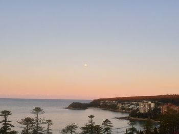 Scenic view of sea against clear sky during sunset