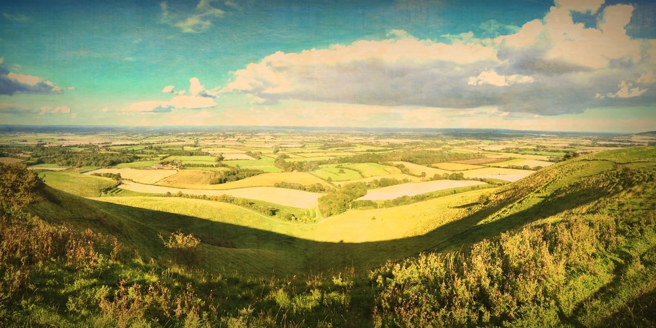 landscape, sky, tranquil scene, scenics, tranquility, cloud - sky, beauty in nature, high angle view, nature, rural scene, green color, agriculture, field, cloud, horizon over land, cloudy, idyllic, aerial view, tree, hill