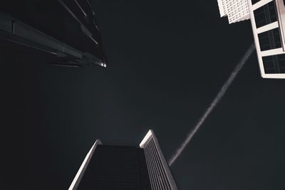 Low angle view of buildings against sky at night