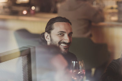 Portrait of smiling man with wineglass in bar