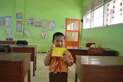 Portrait of boy holding mobile phone