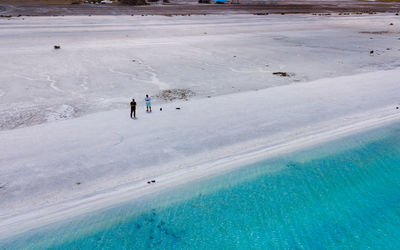 High angle view of people on snow covered land