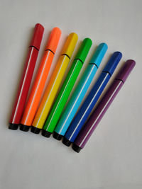 Close-up of colored pencils on white table