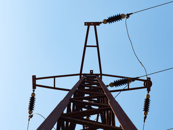 Low angle view of metallic structure against clear blue sky