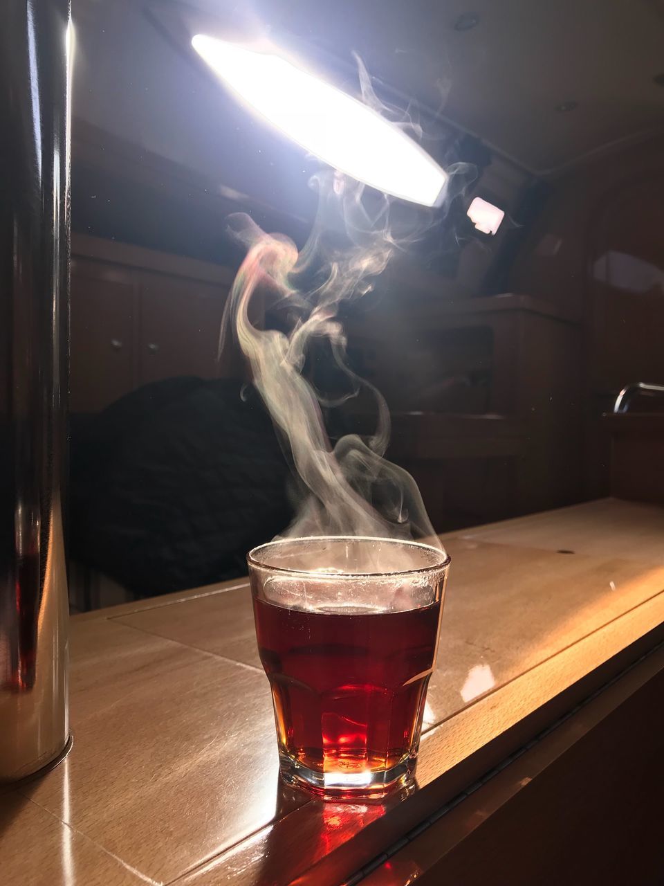 CLOSE-UP OF DRINK ON TABLE AT NIGHT