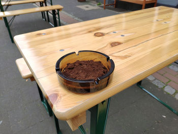 Ashtray with coffee powder in it on a table corner