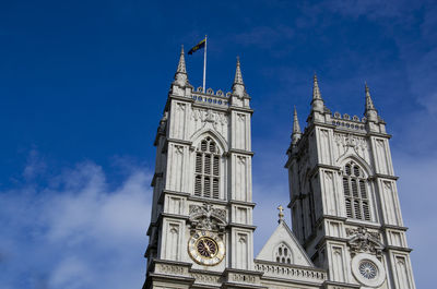 Low angle view of bell tower against blue sky