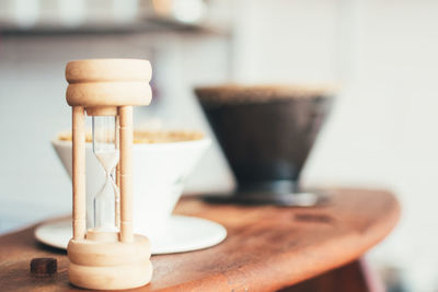 Close-up of hourglass on table at cafe