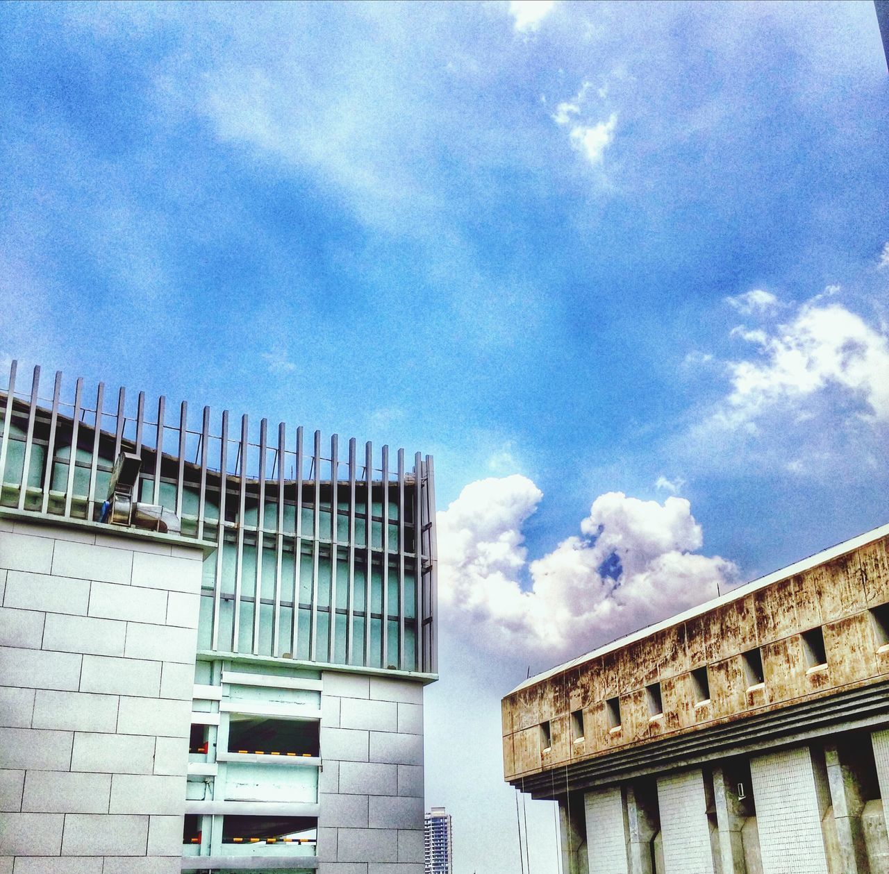 architecture, built structure, building exterior, low angle view, sky, cloud - sky, building, cloud, cloudy, day, outdoors, city, no people, old, blue, text, window, architectural column, high section, history