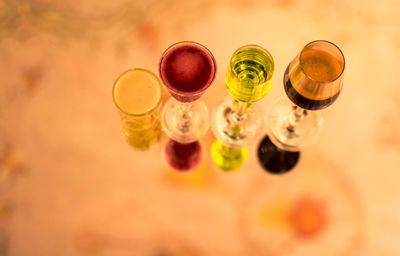 High angle view of drinks in wineglasses on table
