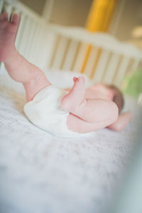 Close-up of baby girl in crib