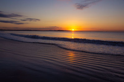 Scenic view of sea against romantic sky at sunset