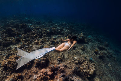 High angle view of woman swimming in sea