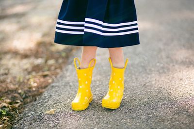 Low section of girl wearing rubber boots