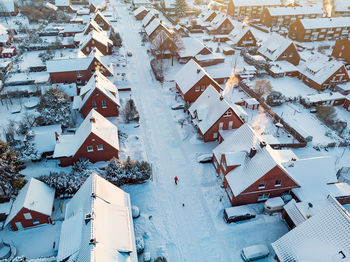 High angle view of snow covered houses in city