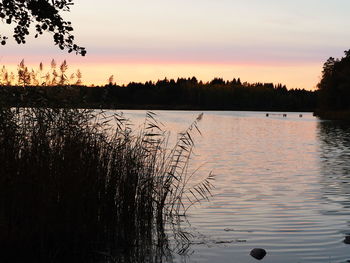 Scenic view of lake against sky during sunset