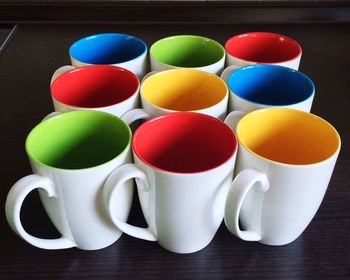 Colorful cups on table