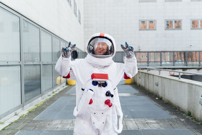 Portrait of man standing in front of building