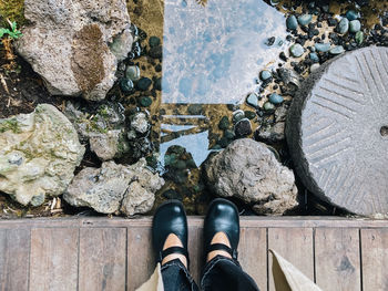 Low section of person standing on rock