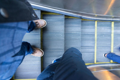 Low section of man standing on tiled floor