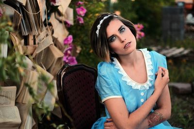 Portrait of beautiful young woman sitting outdoors