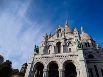 Low angle view of historic building against blue sky