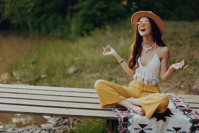 Young woman sitting on bench