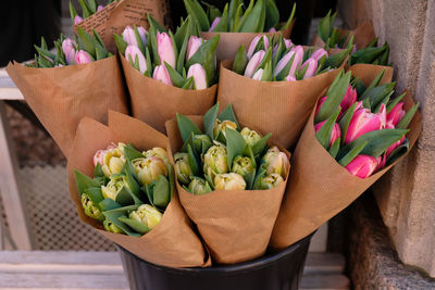 Beautiful bouquet is packaged in kraft paper in flower shop. modern ecological design, loft, craft.