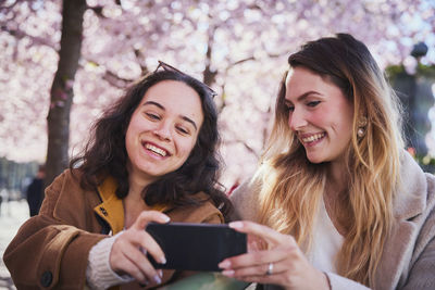 Smiling young women taking selfie