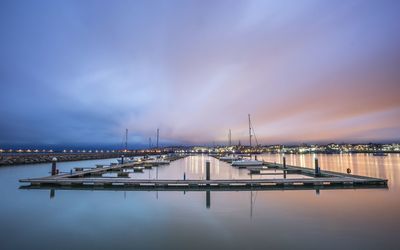 View of commercial dock against cloudy sky