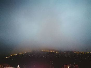 High angle view of illuminated buildings against sky at night