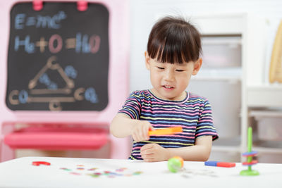 Young girl playing science experiment at home 