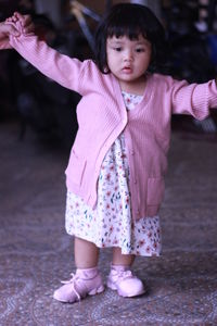 Cute girl standing with pink petals
