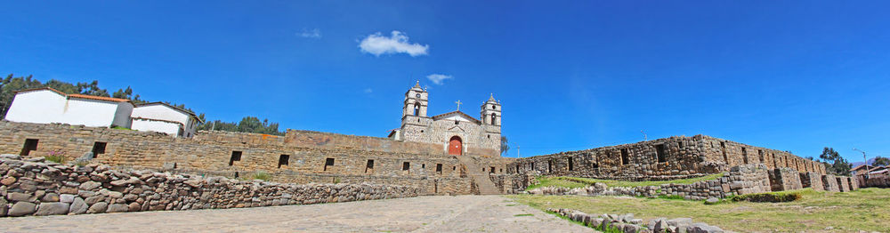 Low angle view of historical building against blue sky