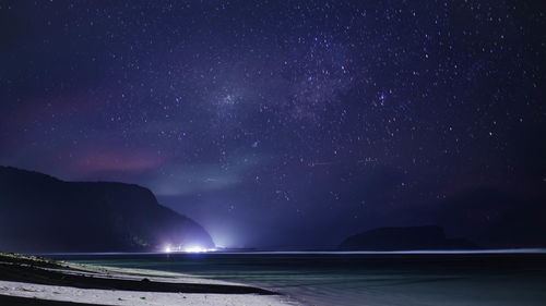 Scenic view of sea against star field