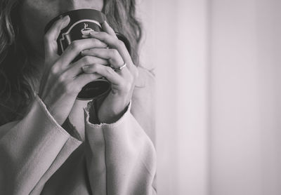 Midsection of woman photographing with mobile phone