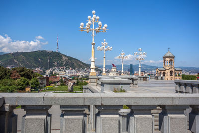 View of city buildings against blue sky