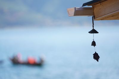 Close-up of hanging over sea against sky