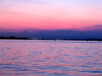 Scenic view of sea against romantic sky at sunset