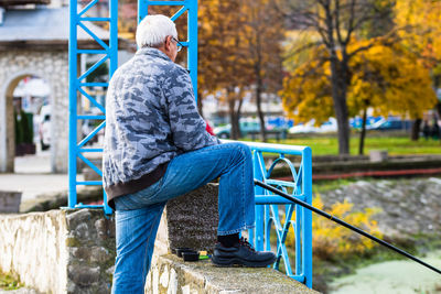 Rear view of man in park during autumn