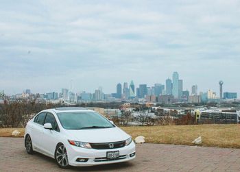 Car in city against sky