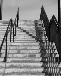 Low angle view of staircase by building against sky