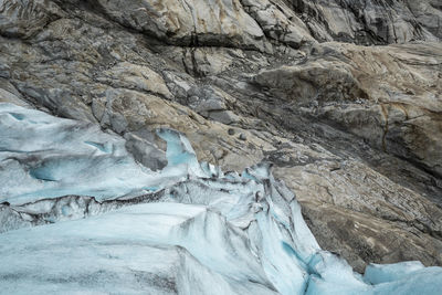 Glacier edge against rock formation