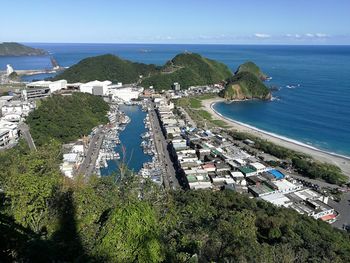 High angle view of sea and buildings against sky