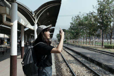 Full length of woman standing on railroad track