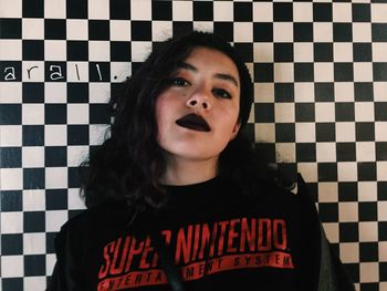 Portrait of beautiful young woman standing on floor