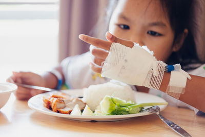 Close-up of girl eating food