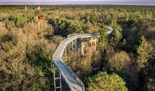 High angle view of bridge over road amidst trees